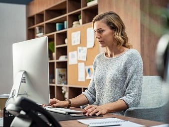 Woman working on office computer