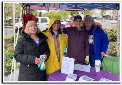 Group of ladies under a canopy on a rainy day