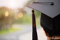 Graduate looking down a road