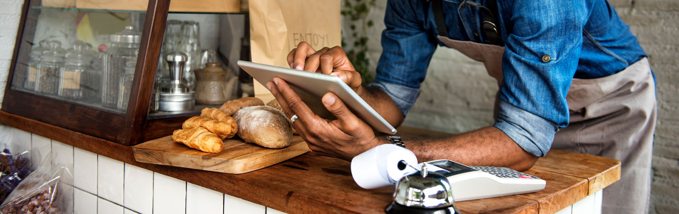 Man at work looking at his tablet