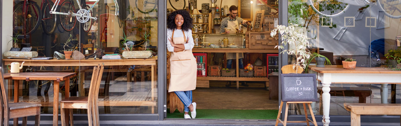 Woman standing in the doorway of her business