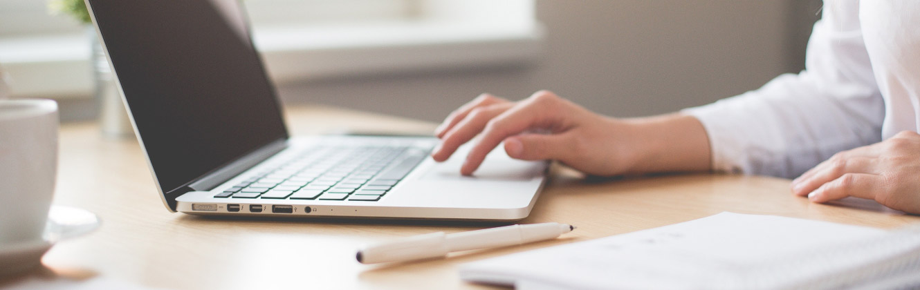 Typing on a laptop