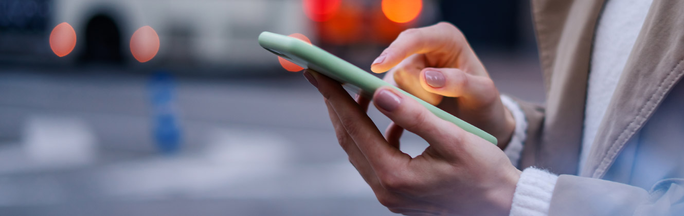 Woman on the street using her phone