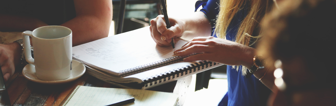 A woman writing in a notebook