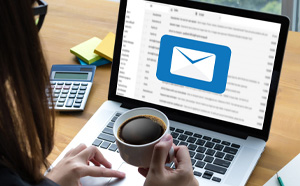 Woman opening an email on a laptop